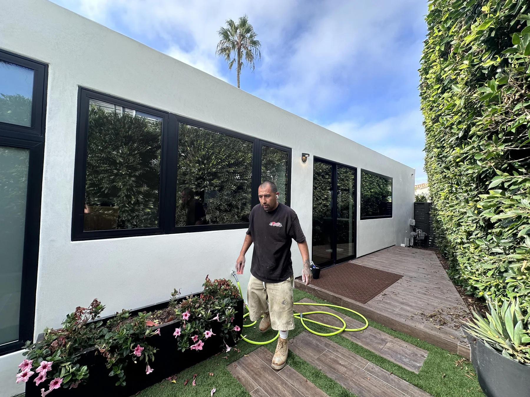 Maya Stucco Inc. crew member finishing a smooth white stucco wall on a San Diego County home