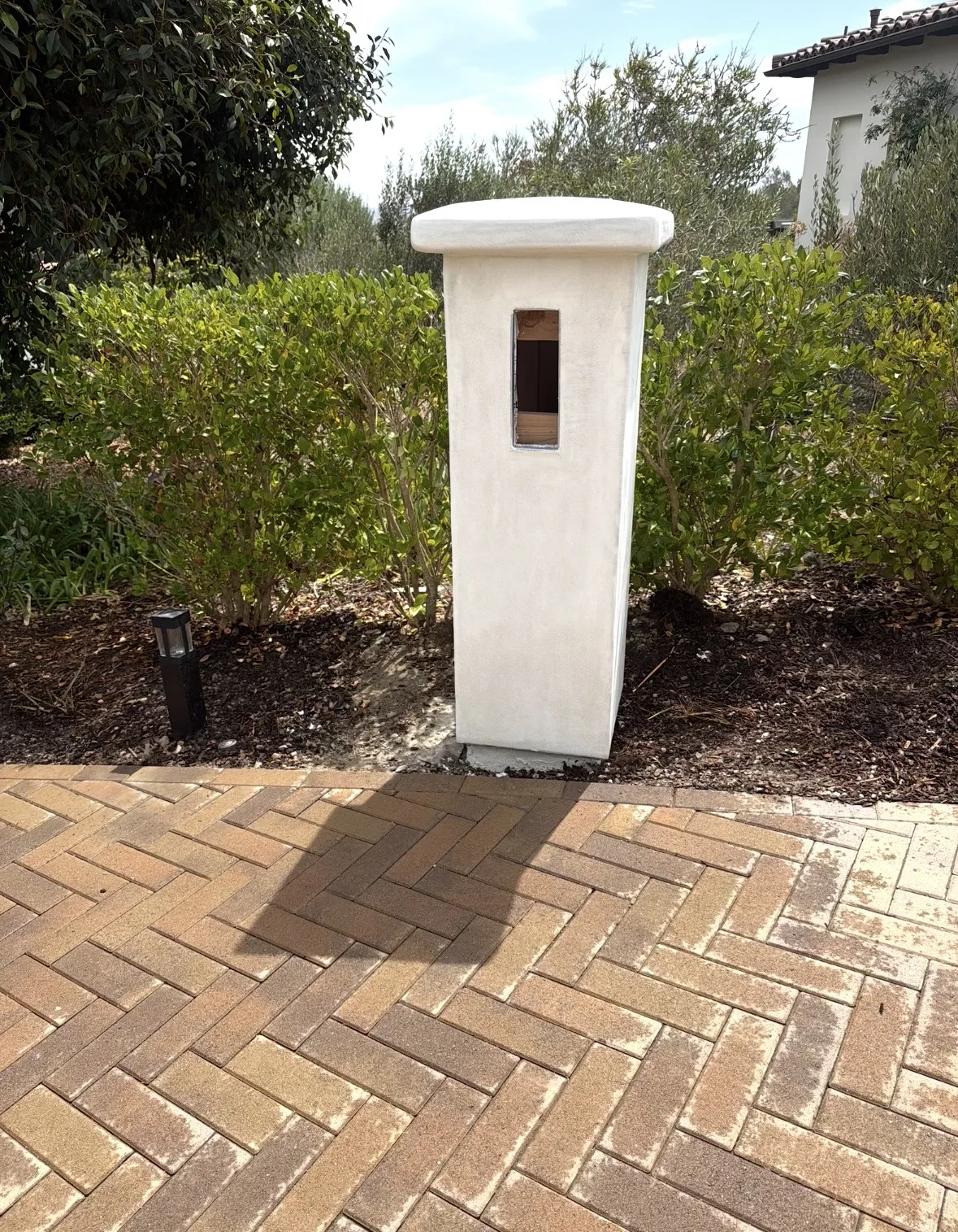Hand-finished stucco entry pillar with a smooth troweled cap detail