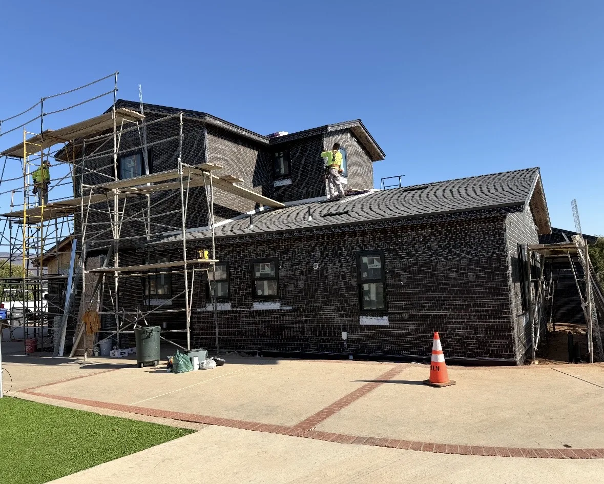 Wire lath and weather-resistive barrier installed over a two-storey home in Bonita, California