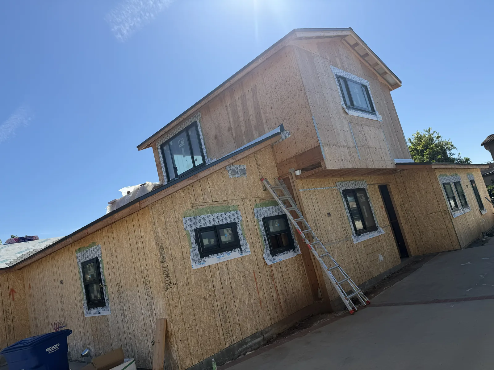 New construction in Bonita with bare sheathing and taped window flashing before lath and stucco