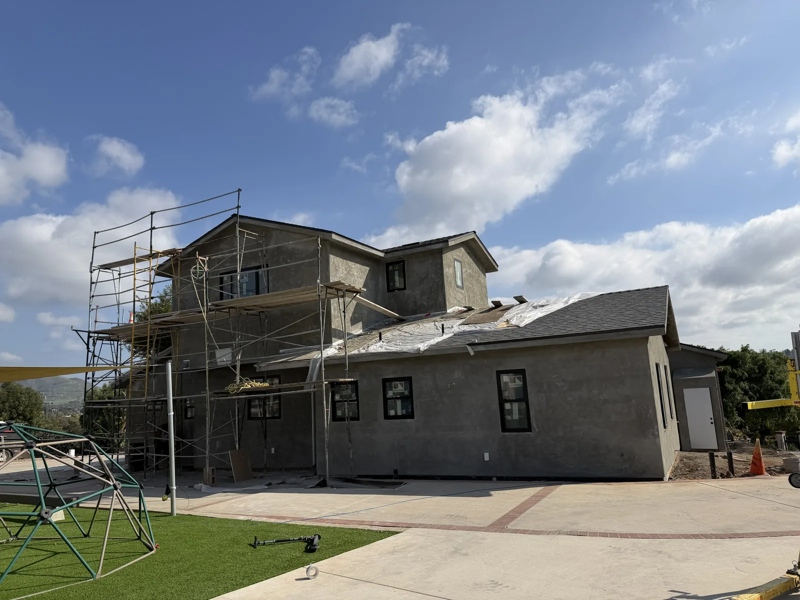 Brown coat applied and curing on a new construction stucco project in Bonita