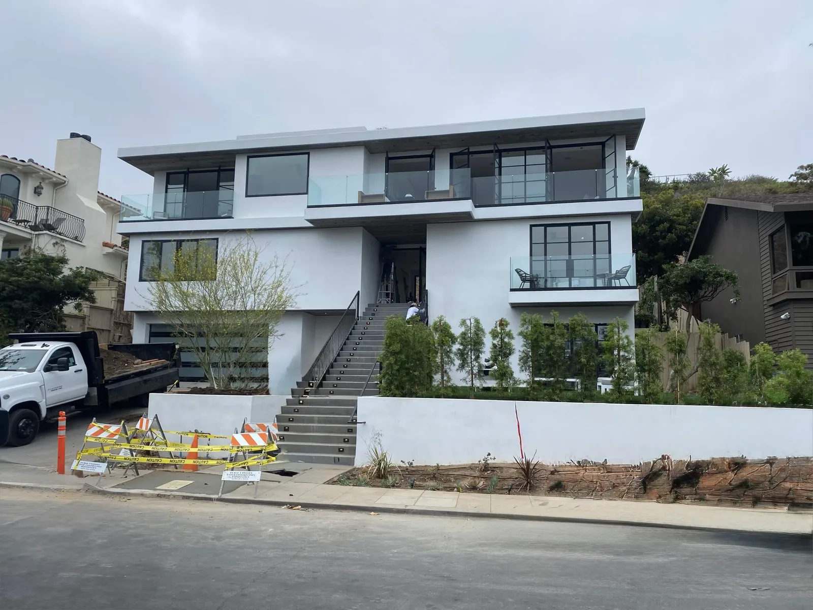 Completed white stucco exterior on a three-level modern home in La Jolla by Maya Stucco Inc.