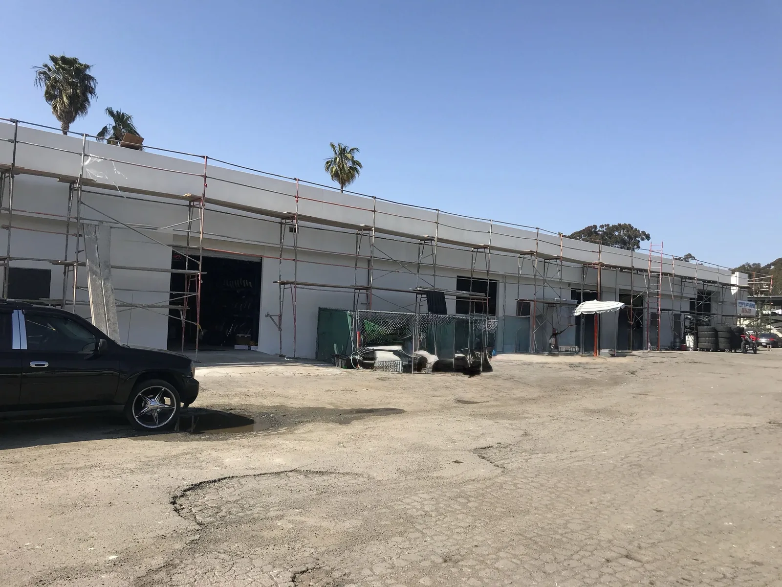 Scaffolding in place during lath and plaster refinishing on an Oceanside commercial building